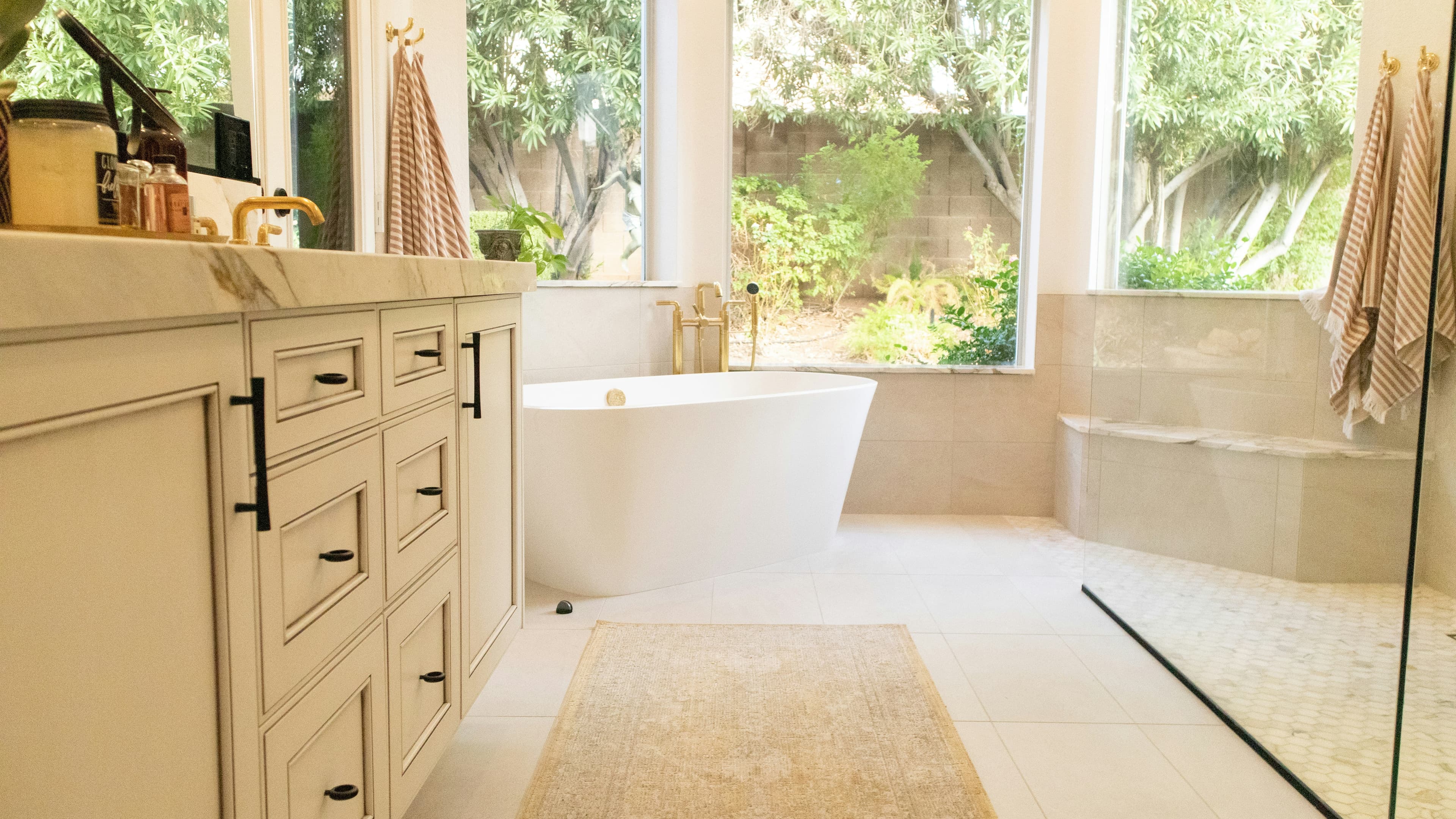 Bathroom with a wood vanity and a freestanding bath