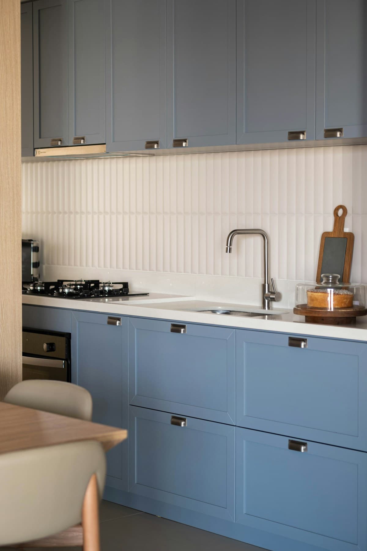 Blue cabinet fronts paired with stainless steel appliances