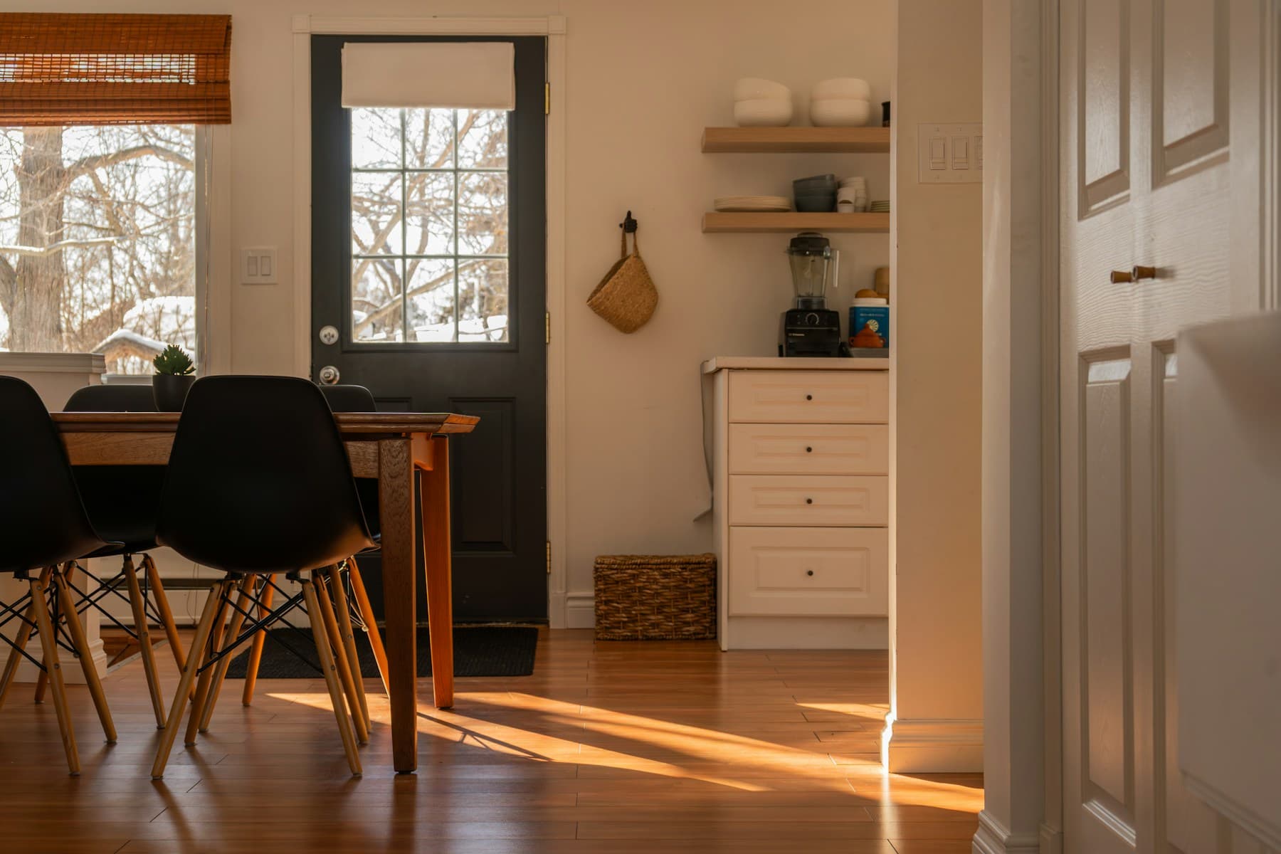 Sunlight falling across a welcoming dining area and kitchen