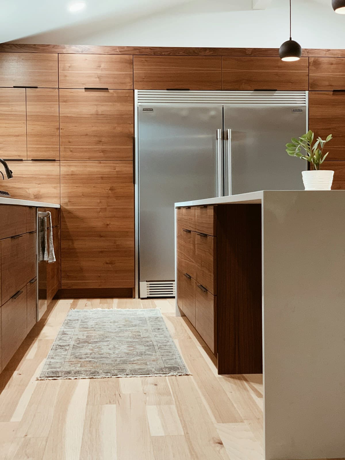 Full-height wood cabinets surrounding a refrigerator